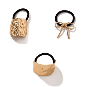 Three-piece golden metal hair tie set featuring hammered and bowknot designs with black bands