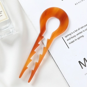 U-shaped acetate hair pin in amber tortoiseshell with anti-slip design for buns