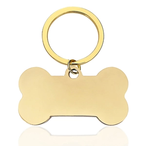 Polished gold bone-shaped pet ID tag with a metallic ring on a white background