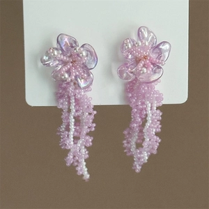 Detail of pink floral beaded tassel earrings with crystal petals on display card