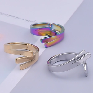 Detailed view of three-layer intertwined geometric rings in gold, silver, and rainbow colors