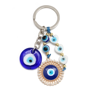 Detail view of Evil Eye keychain with resin pendants, rhinestones and blue woven beads