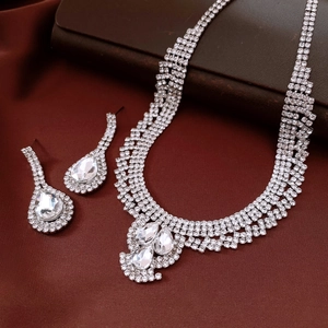 Silver multi-layer teardrop rhinestone necklace and earring set on dark red silk background