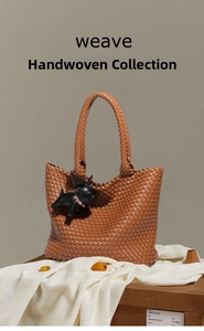 Detailed weave pattern of the brown leather tote bag with a small black bulldog charm