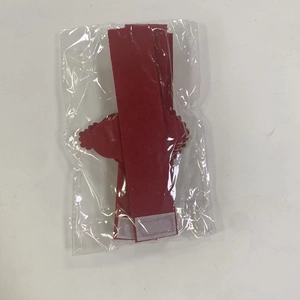 Detail of red Santa napkin ring with velcro fastener in protective packaging