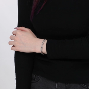 Silver stainless steel NK Cuban link chain bracelet shown on a model wrist against white background