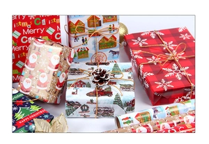 Close-up of festive Christmas wrapping paper styles with reindeer and snowflake patterns