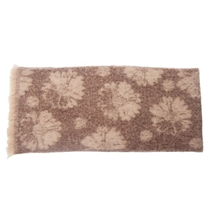 Detail of a brown and beige floral scarf with fringe edges on a white background