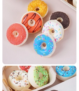 Detail of assorted realistic PU donuts with colorful icing and sprinkles on table
