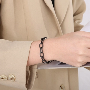 Sleek matte black stainless steel oval link chain bracelet for men and women on wrist