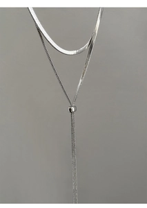 Detail of silver double-layered snake chain necklace with adjustable Y-shaped tassel design