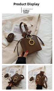 Detail view of coffee leather bucket bag with gold ring buckle and drawstring closure