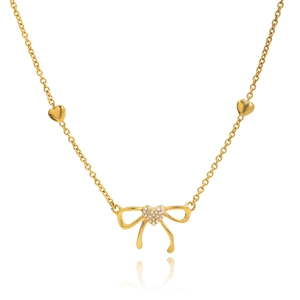 Macro shot of gold bow pendant with sparkling heart zircon and dainty heart chain links