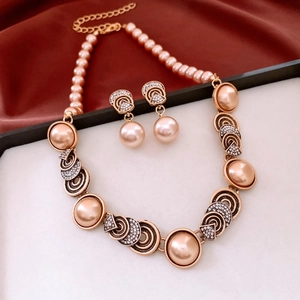 Detail of vintage champagne pearl and diamond necklace set on dark red silk background