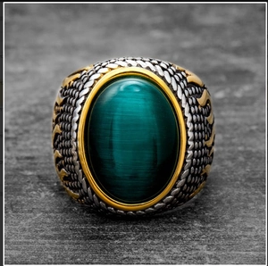 Vintage gold and silver stainless steel men's ring with a green cat-eye gemstone