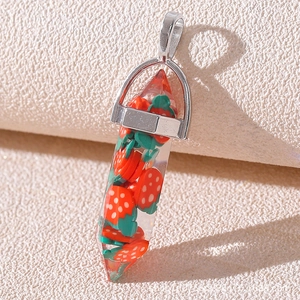 Macro detail of hexagonal resin pendant with strawberry slices and silver metal clasp