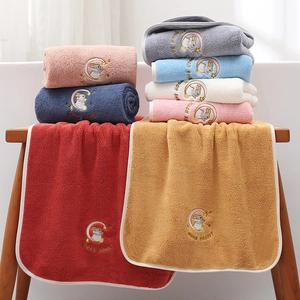 Detail view of thick coral fleece bath towels with moon rabbit embroidery in various colors