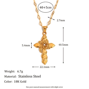 Macro detail of a 18K gold-plated stainless steel cross necklace with rose flower engravings