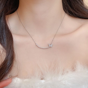 Close-up of 18k gold plated butterfly necklace with sparkling zircon and elegant pearls