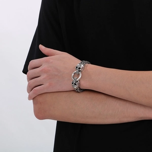 Close-up of punk style stainless steel skull bracelet with round buckle on wrist