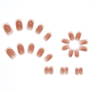 French tip press-on nails with nude pink gradient and creamy white V-shape pattern