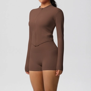 Detail of V-shaped hem on long sleeve zip top and high-waisted shorts in dark brown