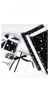 Close-up of birthday gift wrapping paper with gold balloon patterns and ribbon