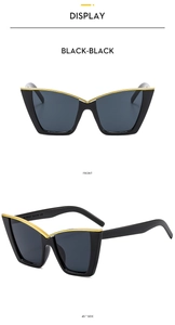 Detail view of black cat eye sunglasses with gold trim showing frame and side temples