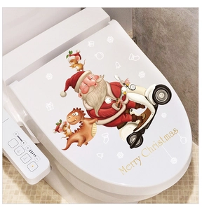 Detailed view of removable Santa on motorcycle sticker on white toilet lid cover