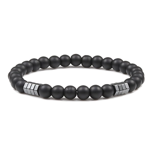 Macro detail of 6mm matte black beads and grey hematite accents on a yoga bracelet