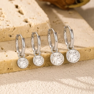 925 sterling silver hoop earrings with round moissanite pendants on stone base