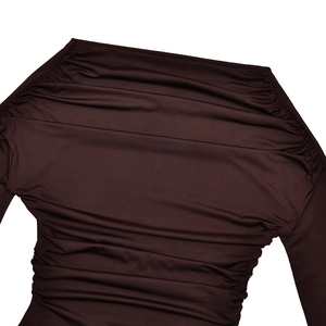 Detailed close-up of the gathered pleat design and soft fabric texture on a dark brown top