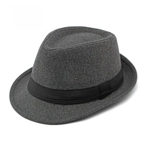 Detail view of the dark grey fedora hat with a black ribbed ribbon and wool texture