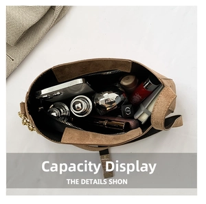 Interior view of brown faux suede bag showing spacious capacity for phone and cosmetics