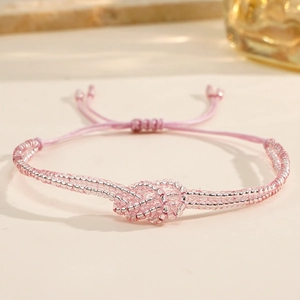 Detail of pink and silver handmade beaded bracelet with adjustable woven sliding knot closure