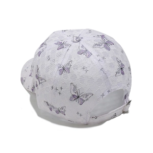 Detail of white lace baseball cap with purple butterfly embroidery and adjustable strap