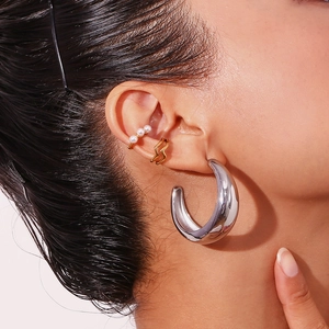 Polished gold crescent hoop earrings and pearl ear cuffs set for a layered fashion look