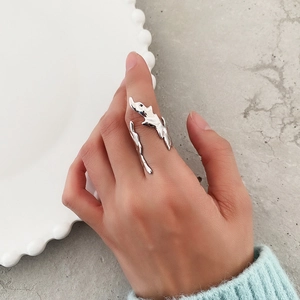 Macro view of sterling silver flame-style ring with irregular liquid metal texture