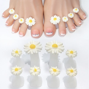 Detailed view of 8 daisy flower silicone toe separators on feet and white background