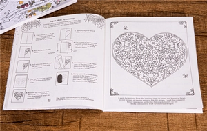 Close-up of symmetric heart drawing tutorial steps on a wooden textured background