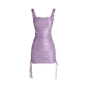 Close-up of purple metallic pleated dress featuring thin straps and textured fabric details