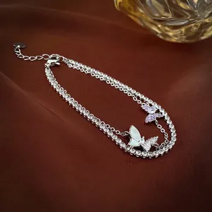 Bracciale a doppio strato con farfalle in zirconi e madreperla su sfondo di velluto