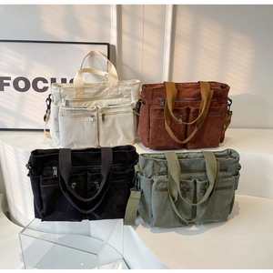 Detail showing high-capacity corduroy tote bags with zipper pockets and woven handles