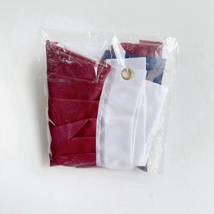 Detail of USA fan flag folded in clear packaging with a visible brass grommet on edge