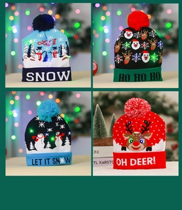 Detail of four colorful festive LED knitted hats with snowman and reindeer patterns