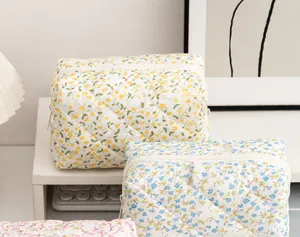 Macro view of quilted cotton fabric and floral print on this large cosmetic bag