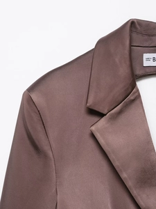 Macro detail of dark brown satin blazer with lapel and shoulder structure