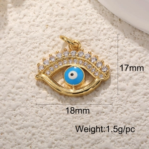 Macro shot of gold Evil Eye charm with blue enamel, showing dimensions 17mm by 18mm