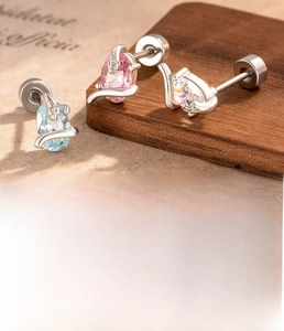 Macro shot of silver titanium steel snake stud earrings with oval cubic zirconia stones