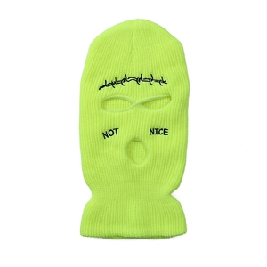 Detail of neon green 3-hole knit balaclava with black barbed wire and NOT NICE embroidery
